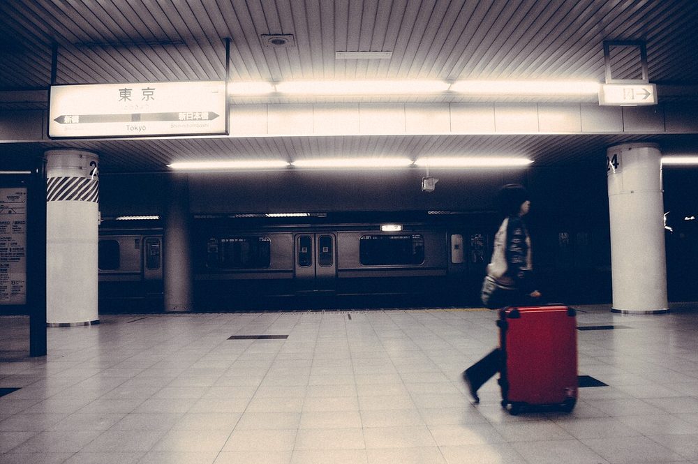 A red suitcase in an underground station